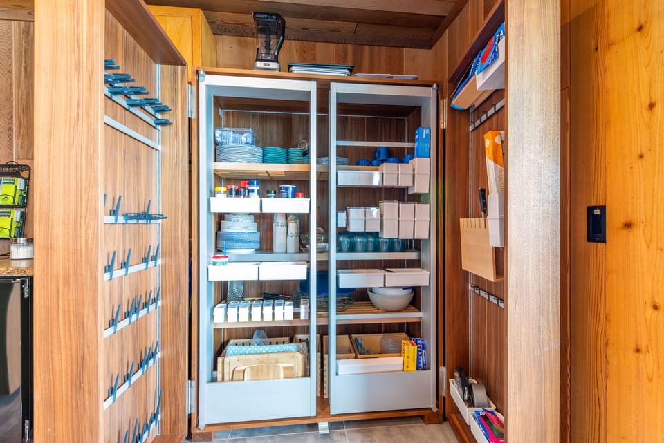 Kitchen is fully-stocked with utensils, condiments, and more.