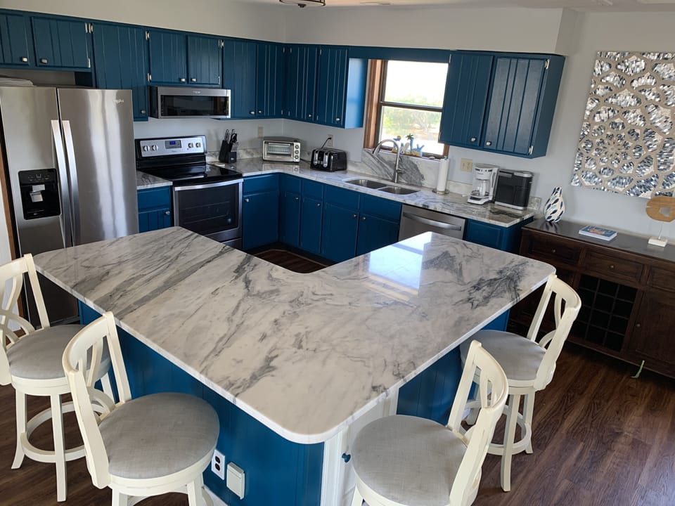 open kitchen with stainless steel appliances and beautiful granite countertops 