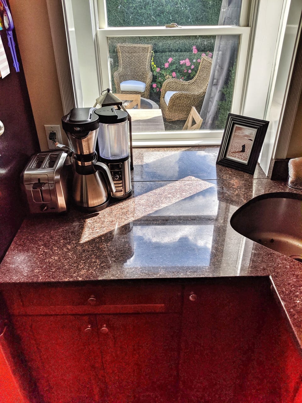 Kitchen looks into private outdoor space on second floor