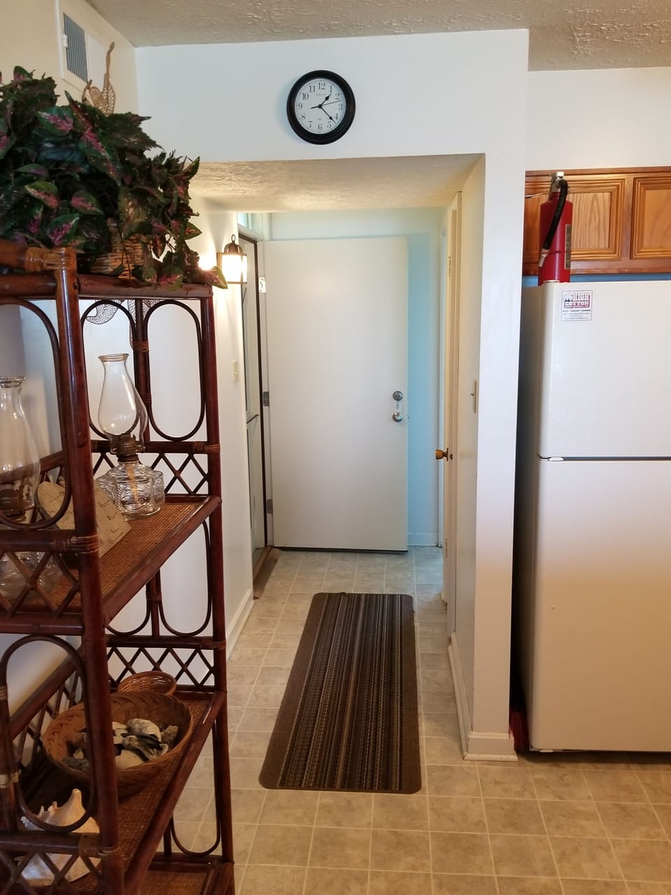 view of entrance door and hall to kitchen