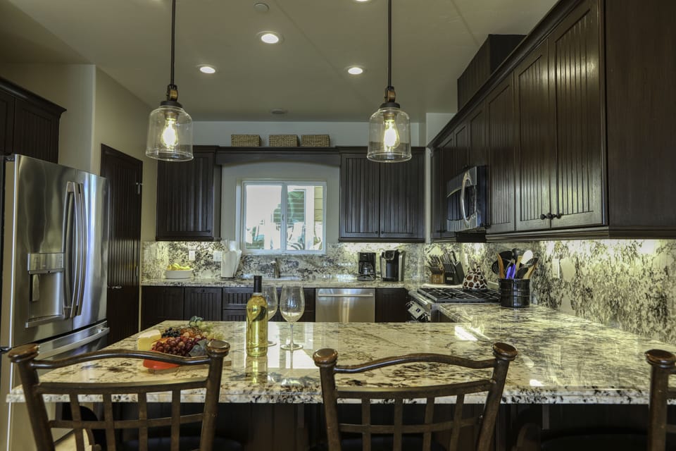 Ample cupboard space where an assortment of serving plates, bowls and cups are stored.