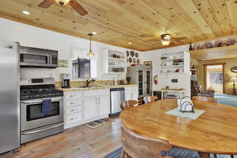 Fully equipped cabin kitchen with ample cabinetry, stove, fridge, microwave, and coffee maker—perfect for cooking meals, morning coffee, and feeling right at home on your stay.