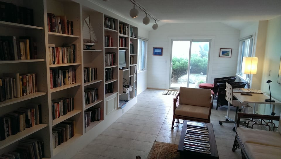Library on main floor with office area and TV area