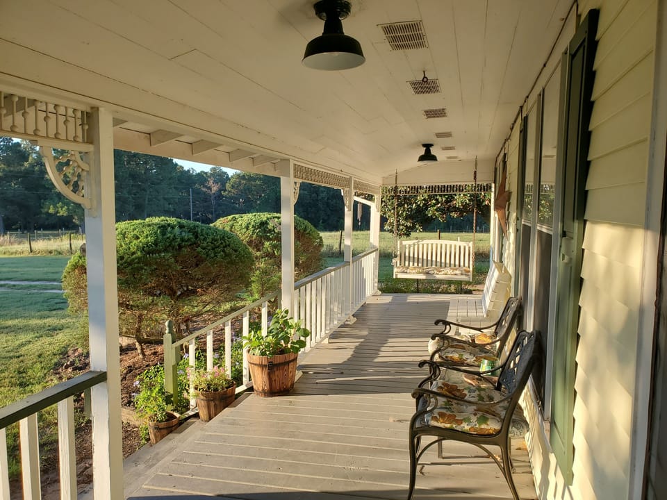 Enjoy coffee in the morning from this one of a kind porch.