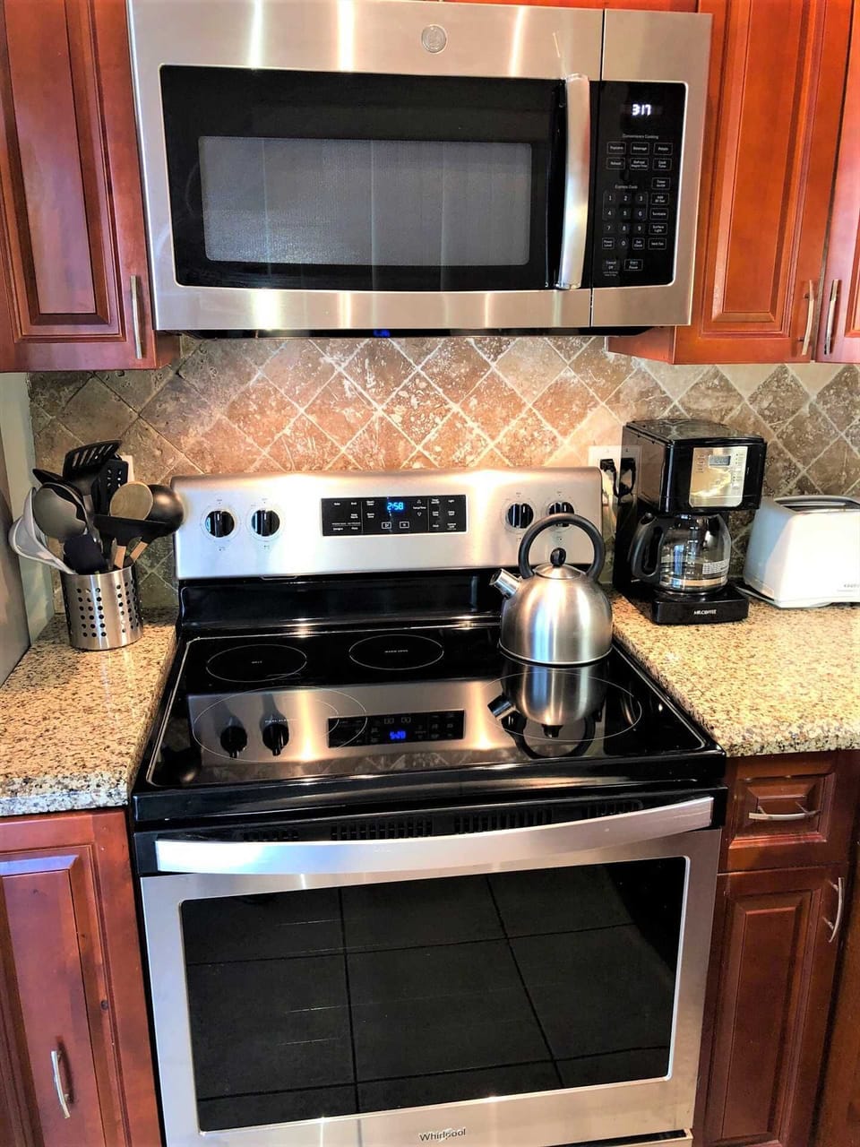 New stainless microwave and glass cooktop range are featured in newly remodeled kithcen.