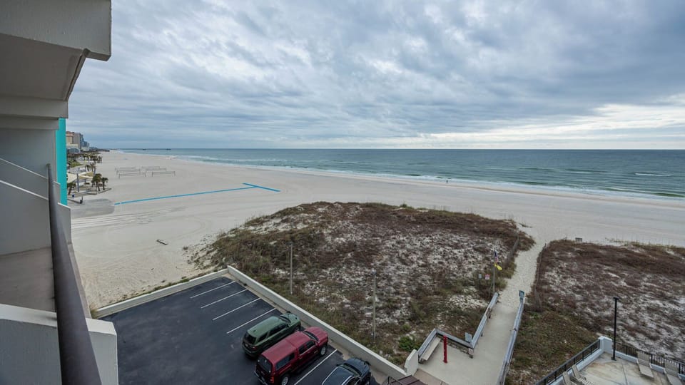 Enjoy stunning beachfront views from this inviting balcony, perfect for relaxation and soaking in the coastal atmosphere