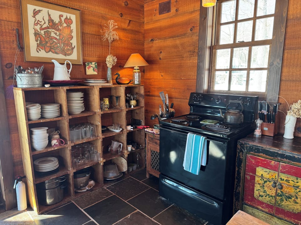 Boathouse kitchen: Stove & cubby w dishes