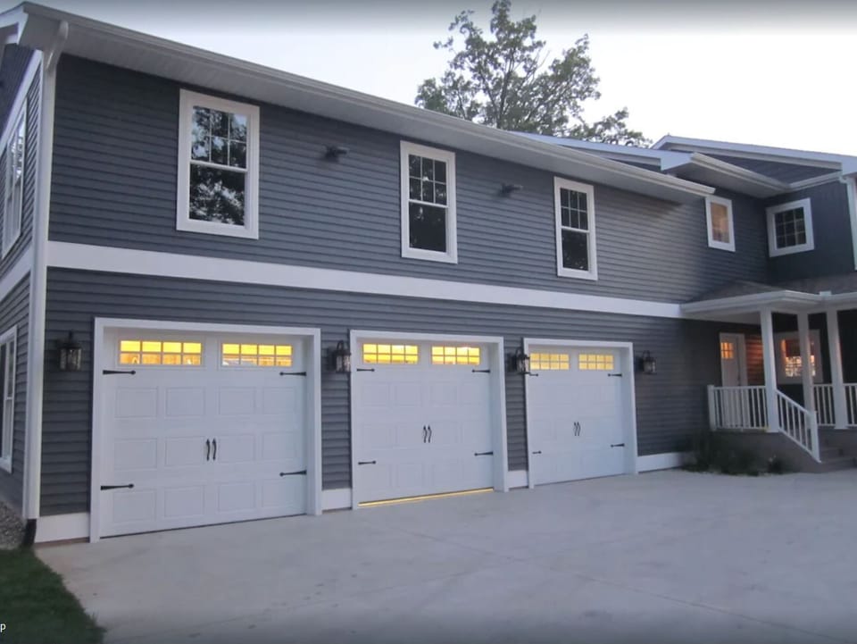Garage and driveway with basketball hoop