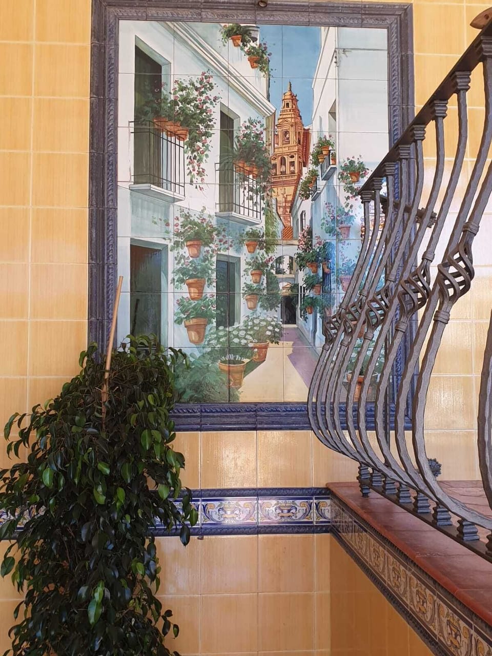 The courtyard is full of tiled pictures of Spanish rural themes