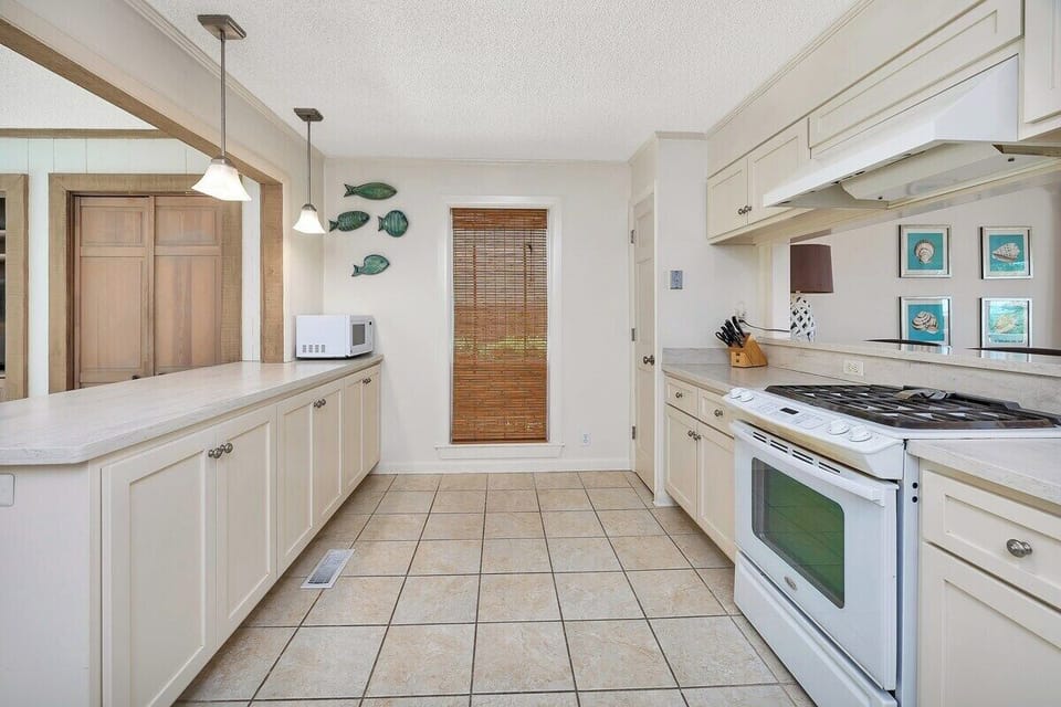 Kitchen area with stove and cabinets