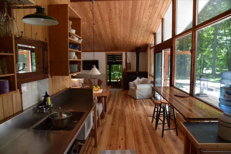 A simple country kitchen with stainless & cherry countertops. 