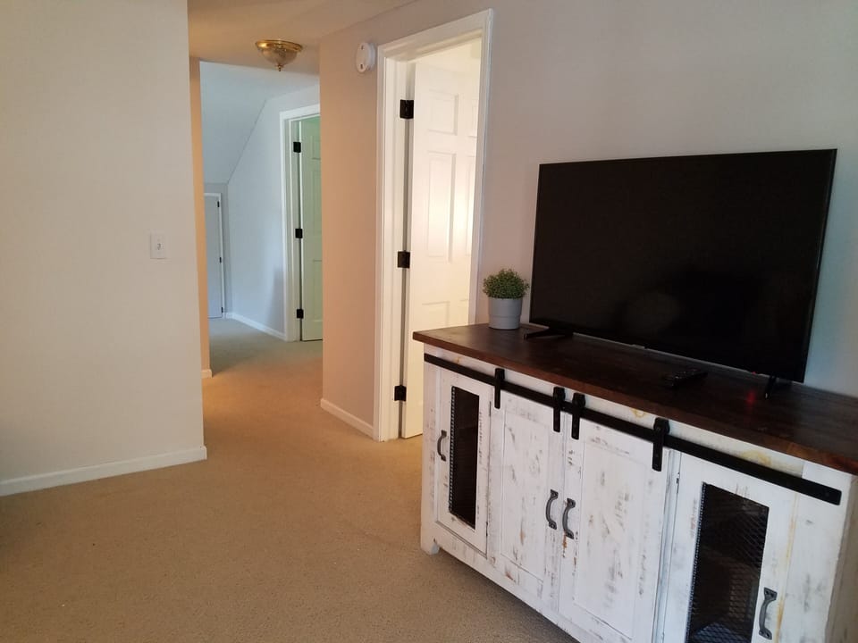 Living area 2 of 3. Cabinet with games, books and toys, all TVs internet & cable