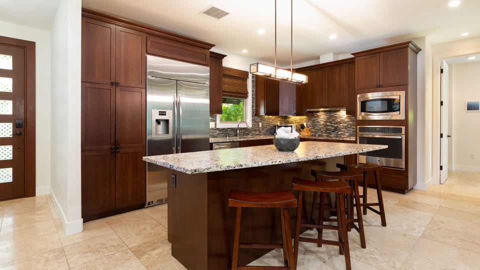 Large island in beautiful kitchen - plenty of room for all the cooks in your family.