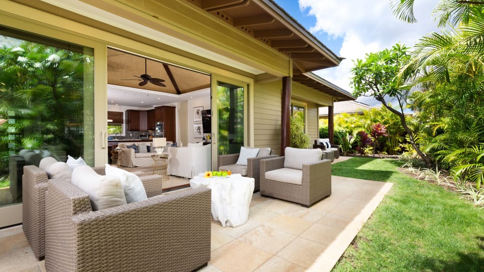 Covered lanai off living room with private grill.