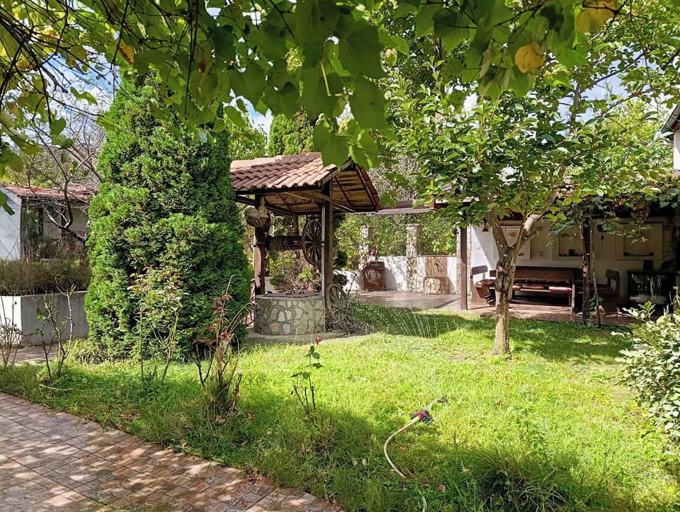 Outside lawn and a dining area that sits eight