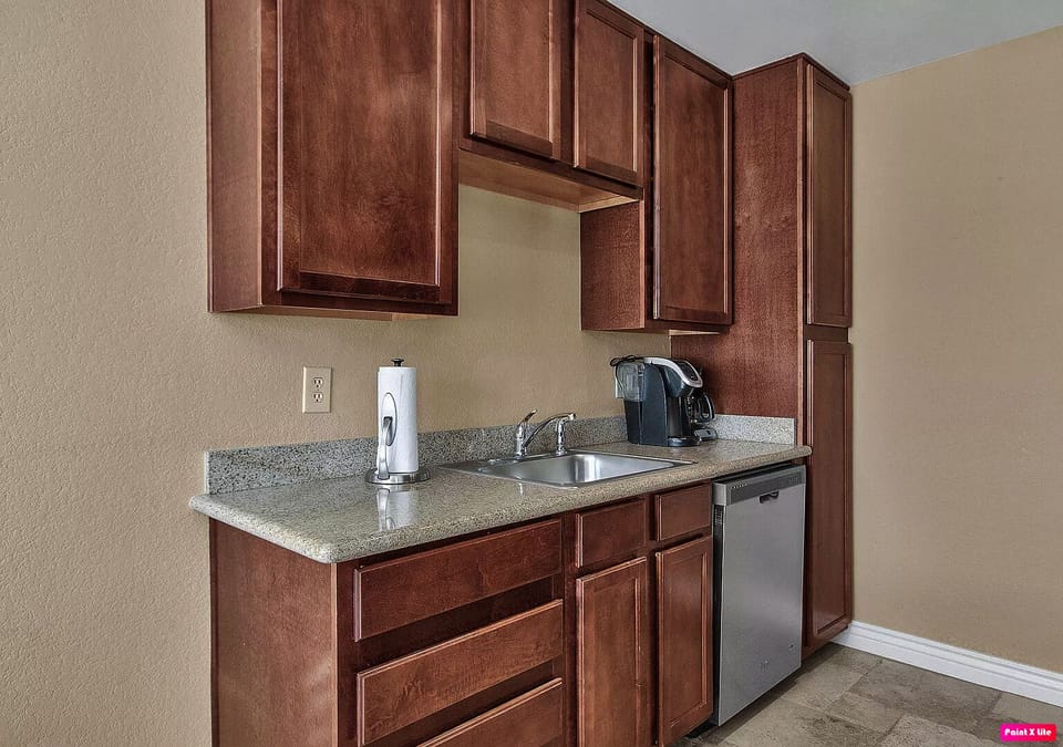 Kitchen with coffee maker & other essentials.