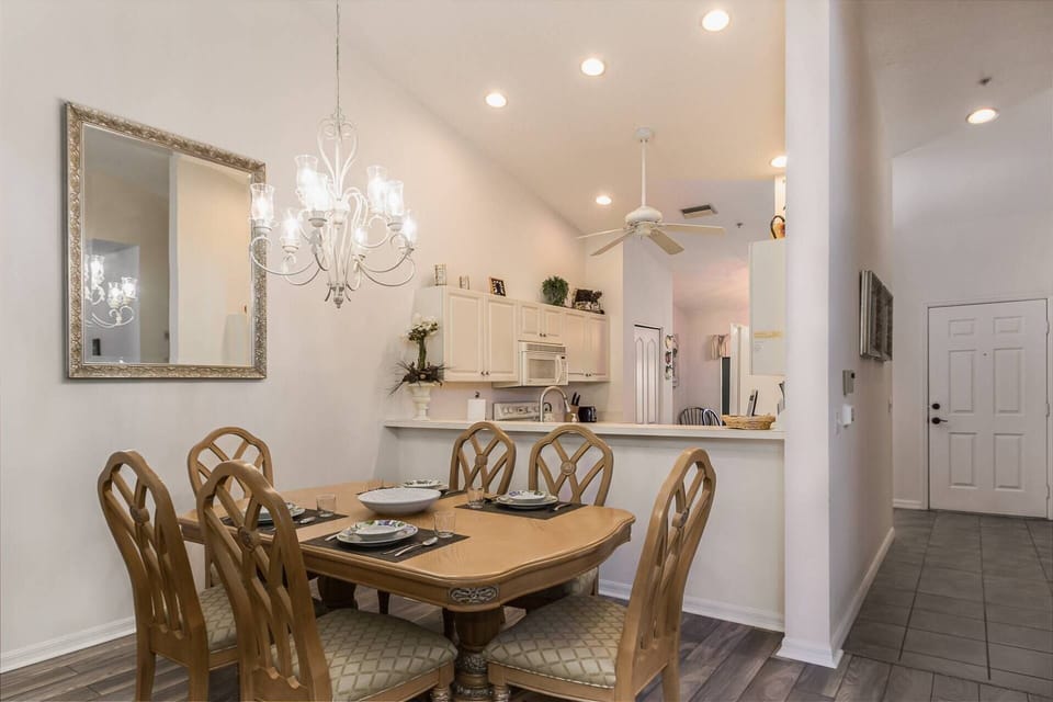 Comfortable dining for 6 open to the kitchen with newer wood tile flooring