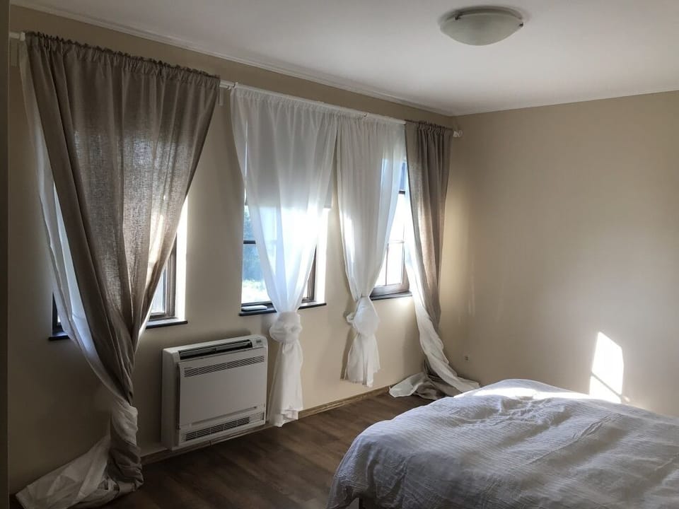 Bedroom 1, simple furnishings and AC/heating unit