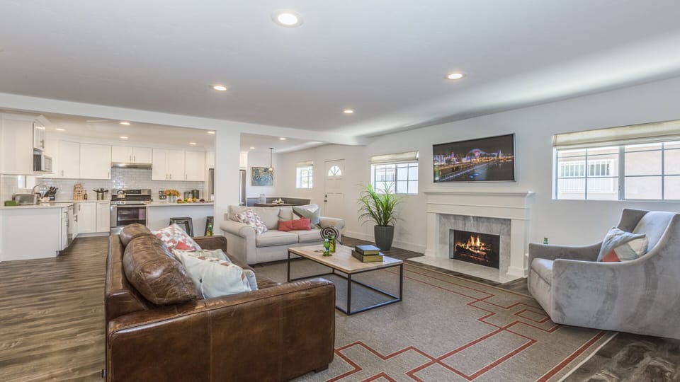 - Living area with fireplace TV and multiple seating arrangements   - Spacious layout ideal for relaxing after exploring local sights   - Perfect for families to gather and share quality time indoors