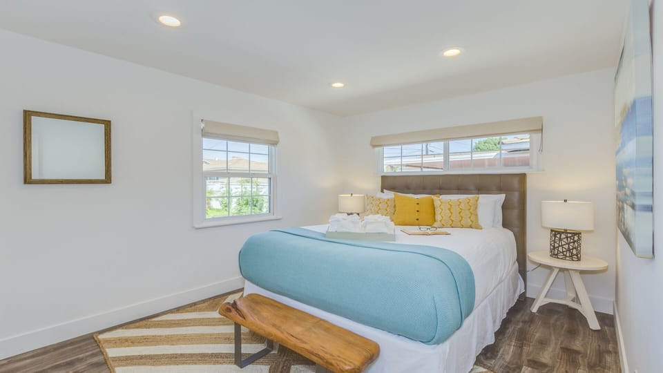 - Queen bedroom with cozy bedding natural light and stylish decor   - Bright windows bring in sunshine creating a welcoming space   - Comfortable retreat ideal for relaxing after a fun filled day
