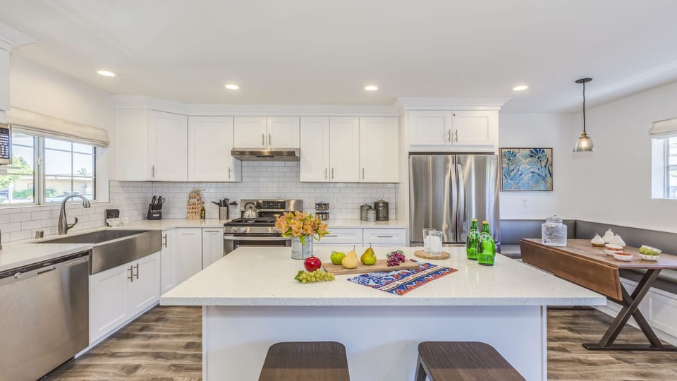 - Bright modern kitchen with large island and bar stool seating   - Stainless steel fridge oven and essentials ready for cooking   - Stylish open design connects to dining space for group meals