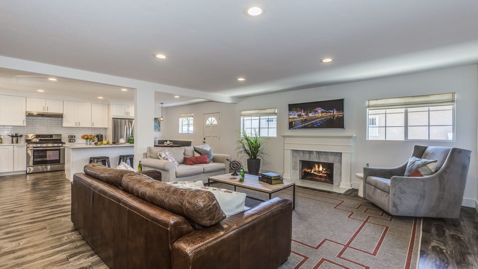 - Spacious living room with cozy leather sofa and warm fireplace   - Large flat screen TV creates a great spot for family movie time   - Comfortable open design ideal for group gatherings and relaxing