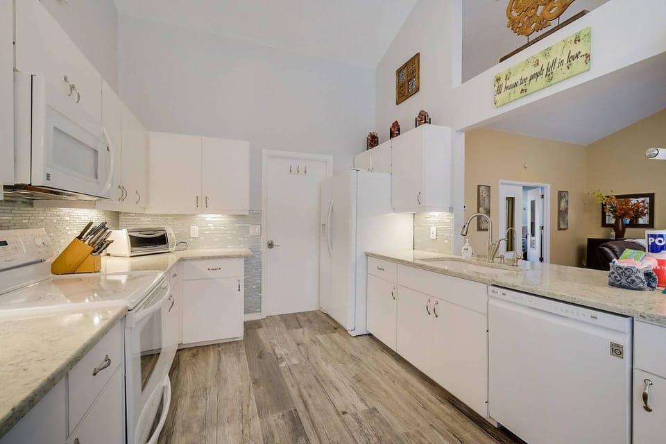 Cook with ease in a well-stocked kitchen featuring full-size appliances and ample storage.