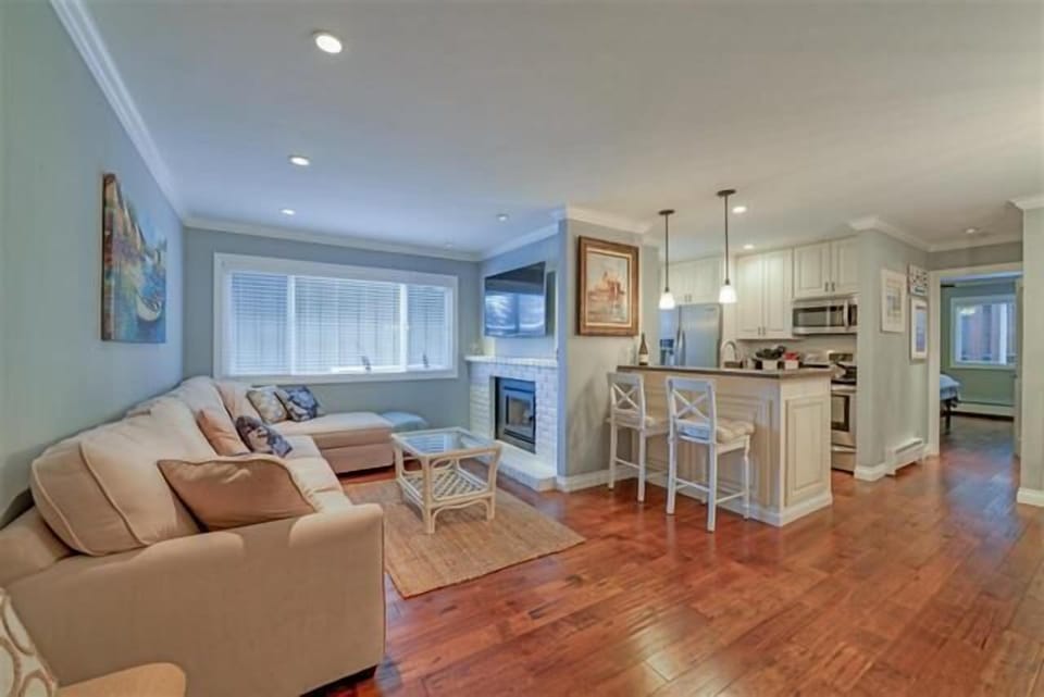 The open-concept design allows for easy flow between the living room, dining room, and kitchen, creating a warm and inviting atmosphere