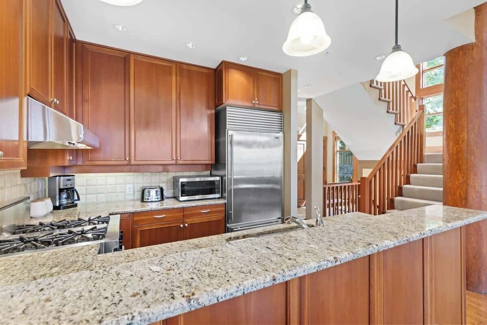- Sleek kitchen design with high-end appliances and open flow  
- Granite counters and pendant lights create a warm cooking space  
- Perfect for preparing group meals or mountain breakfast feasts  