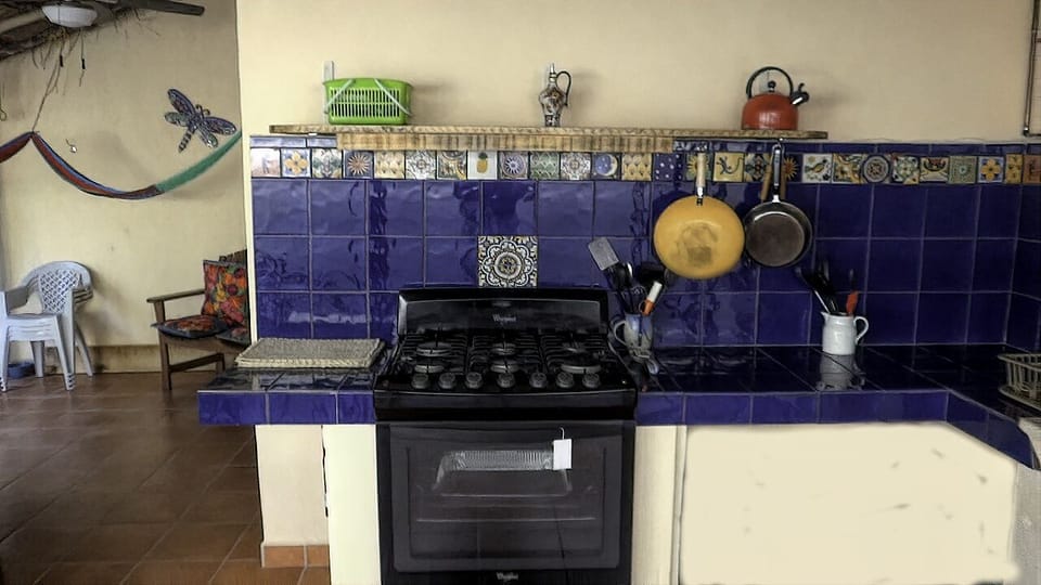 Outdoor kitchen, six burner with oven, plenty of tiled counters, light under the