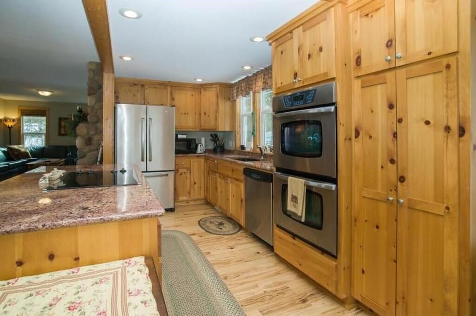 Kitchen is with a double oven, granite, stainless steel appliances