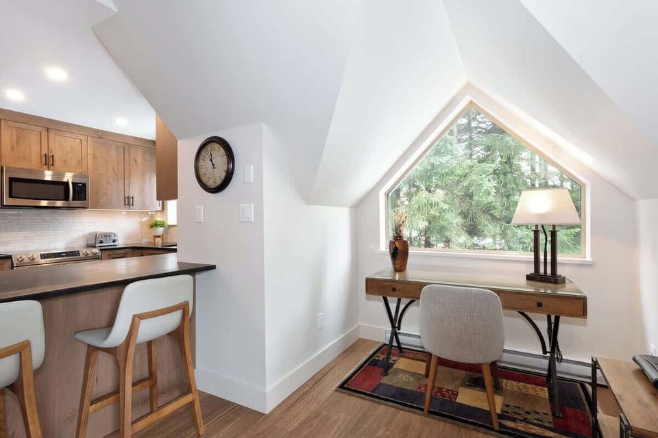 - Bright home office nook with forest-view window and rustic desk setup  
- Peaceful corner perfect for remote work or quiet reading sessions  
- Natural light fills the space creating a calm alpine retreat  