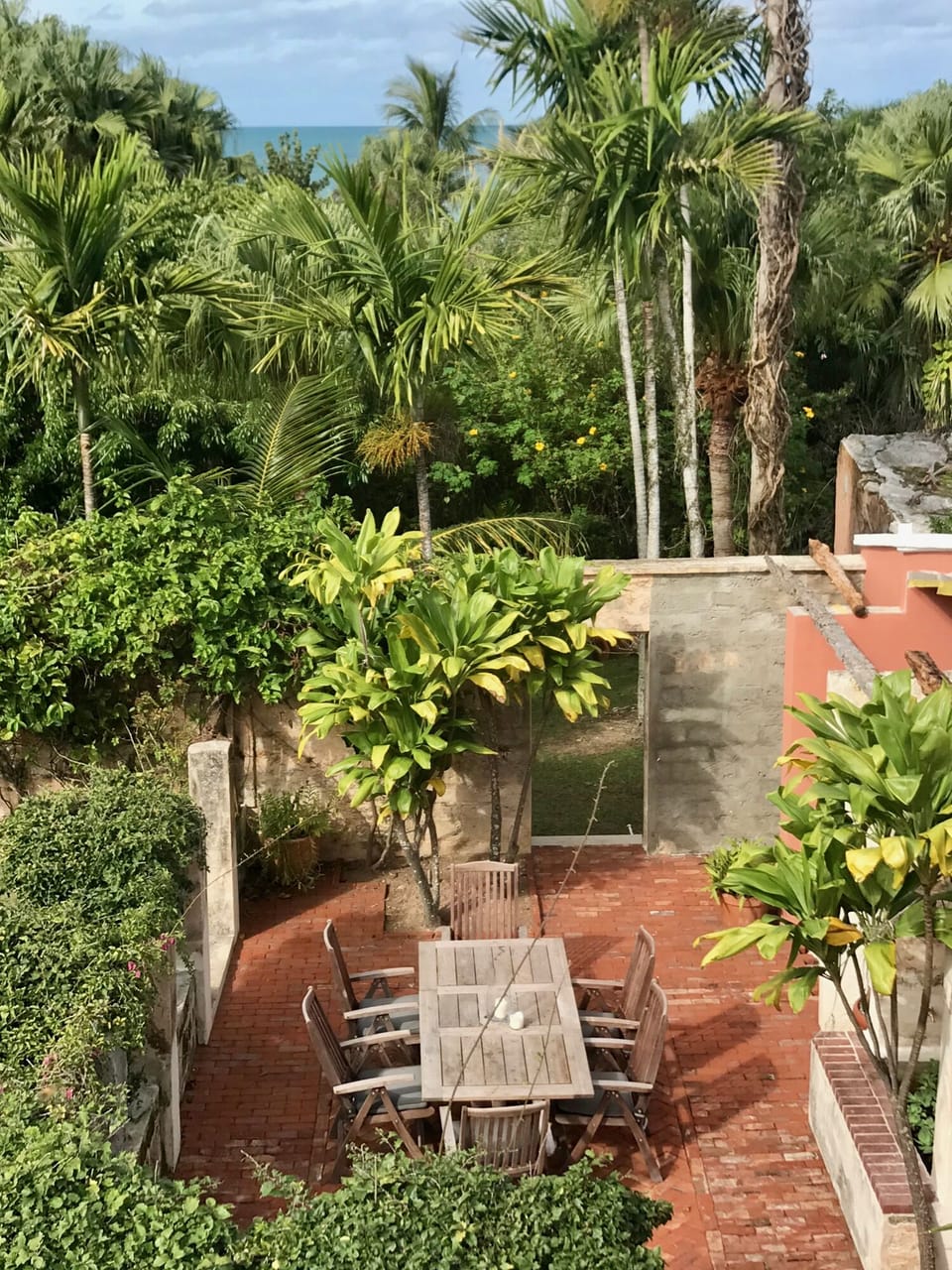 Garden dining with a view of the sea behind