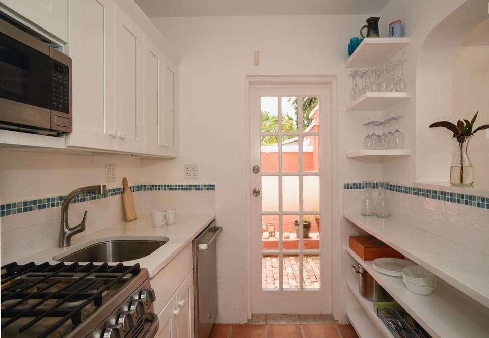 Kitchen with full-size dishwasher, gas stove, fridge, microwave, coffee machine
