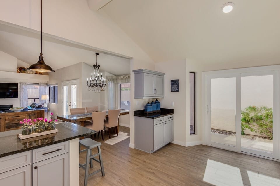 Open kitchen area with seated bar area and access to front room