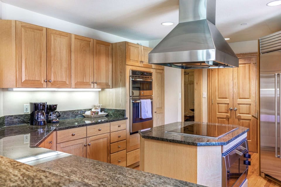Kitchen includes stackable microwave and oven with additional convection oven under the electric burner.