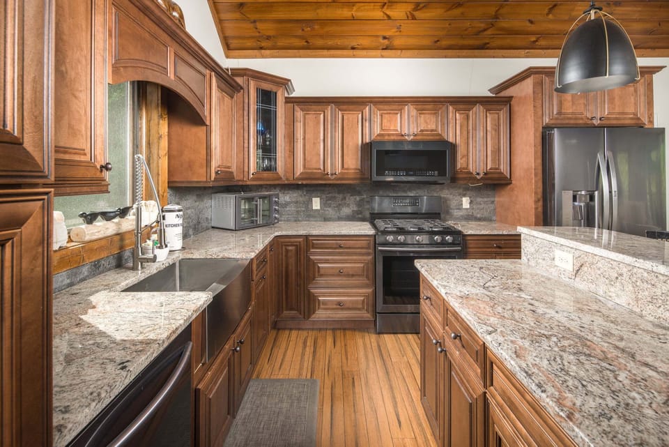 Well-equipped kitchen with granite counters and stainless appliances