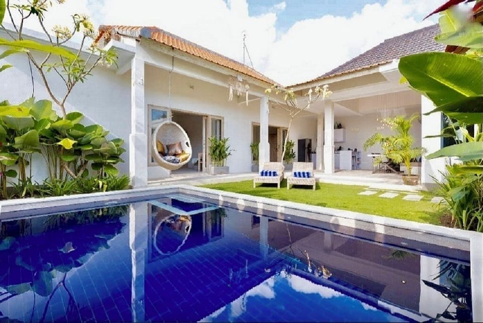 The villa's beautiful garden, with a grass play area for kids and private pool