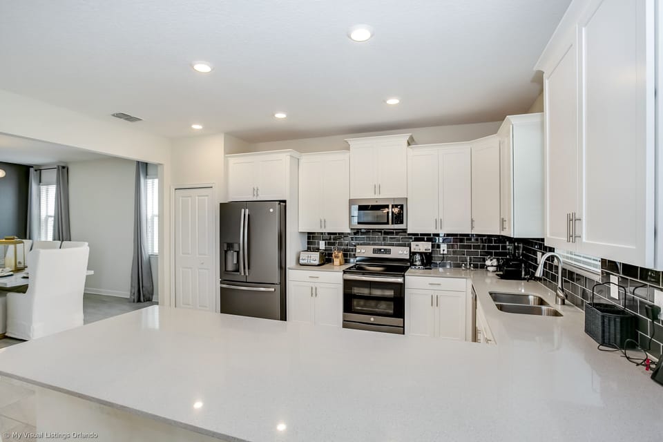 - Sleek Kitchen of the Home in Florida - This Kitchen blends style with functionality - Offering a refined space to unleash culinary creativity -  Sleek stainless steel appliances