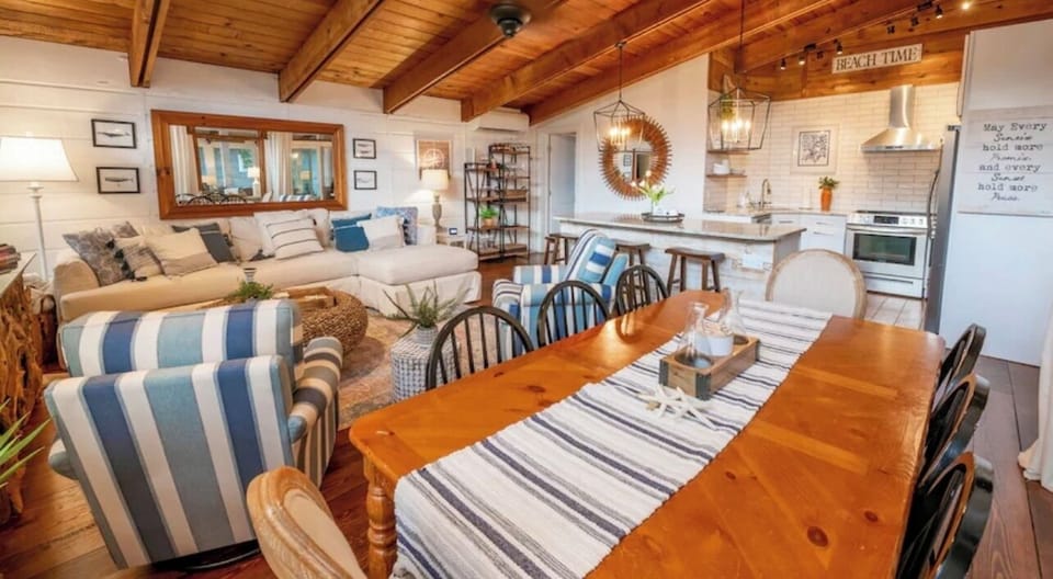 The family room area features a large sectional with cozy arm chairs for relaxing after a day at the beach.