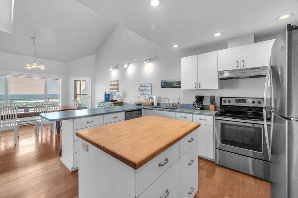 Cook meals while gazing at ocean views from your fully equipped kitchen with stainless appliances and spacious island.