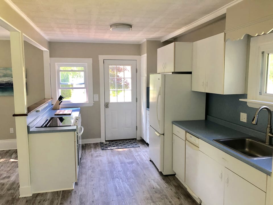 Fully equipped kitchen with dishwasher, stove, microwave, keurig coffee maker