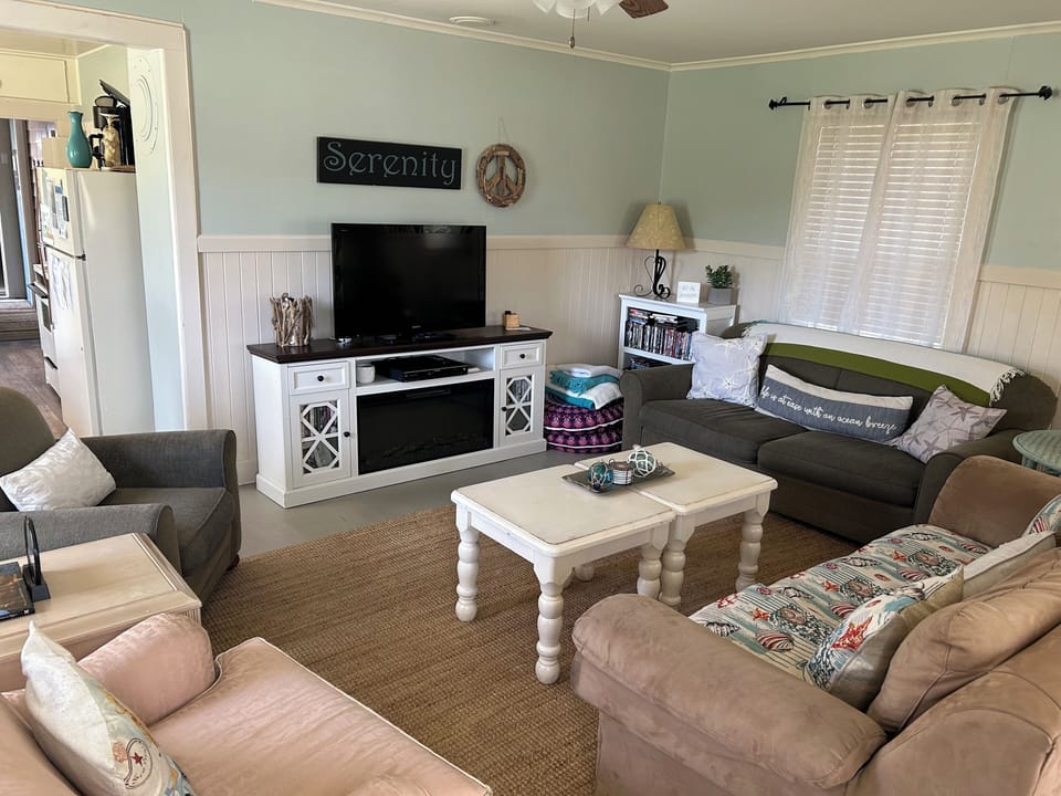 Sink into soft sofas and unwind in this peaceful living room, where you can gather with loved ones around the TV.