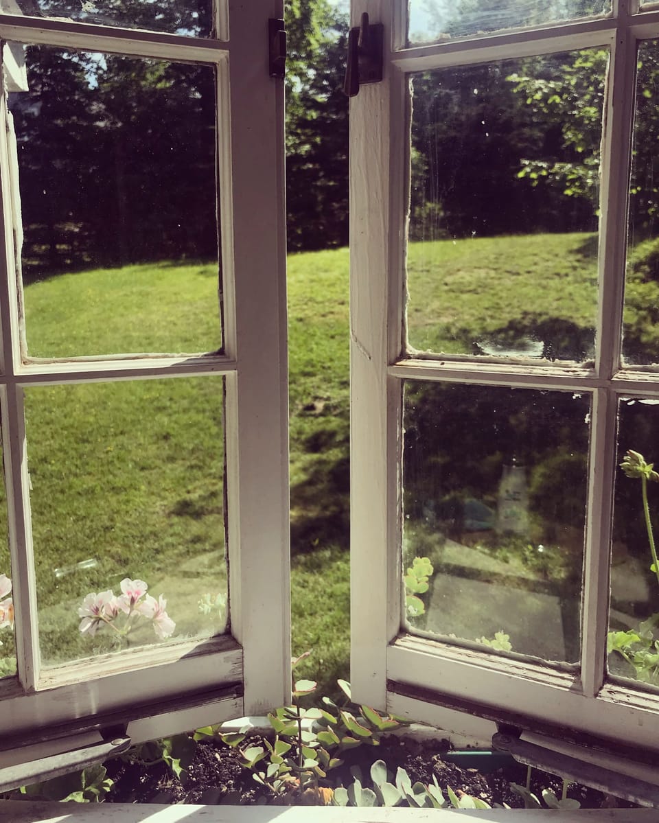 old fashioned crank windows openings to the front yard from the kitchen.