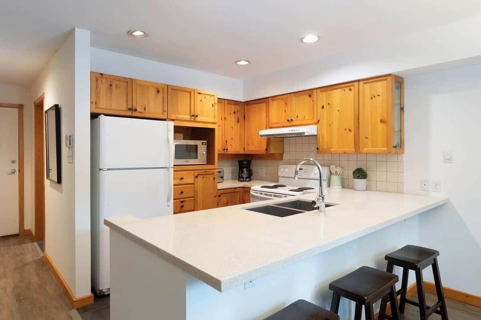 - Bright kitchen with wooden cabinetry and modern appliances  
- Spacious counters perfect for meal prep or casual dining  
- Fully equipped setup for extended stays and home-style comfort  
