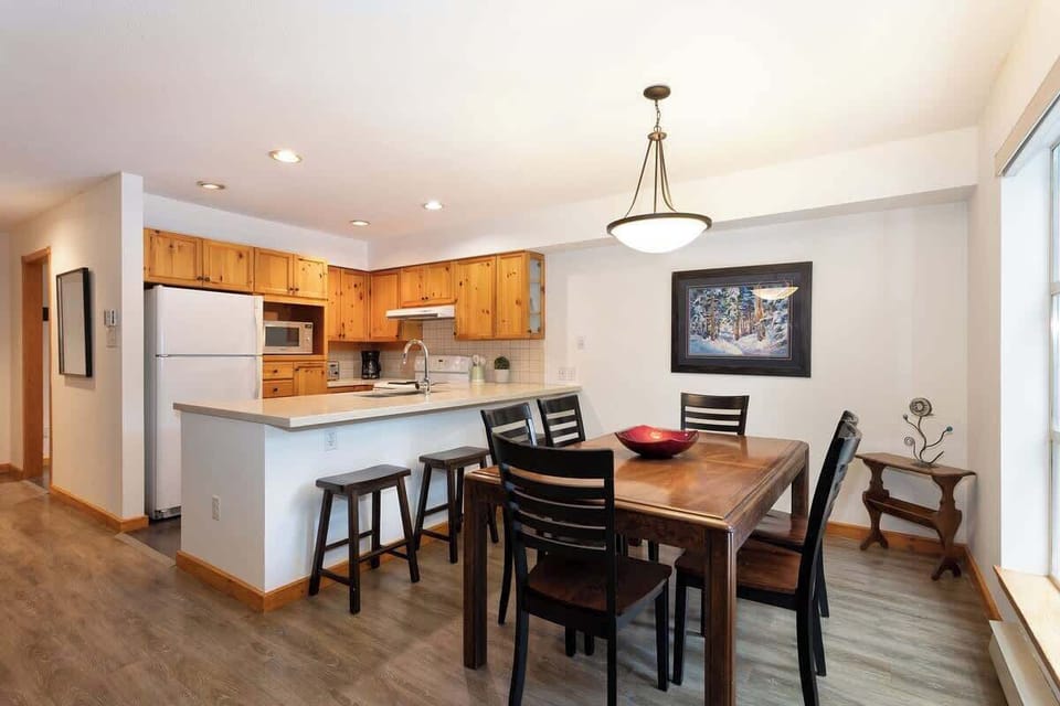 - Open dining and kitchen area with bright natural light  
- Wooden accents and modern lighting create a cozy feel  
- Perfect for family meals after exploring Whistler Village  