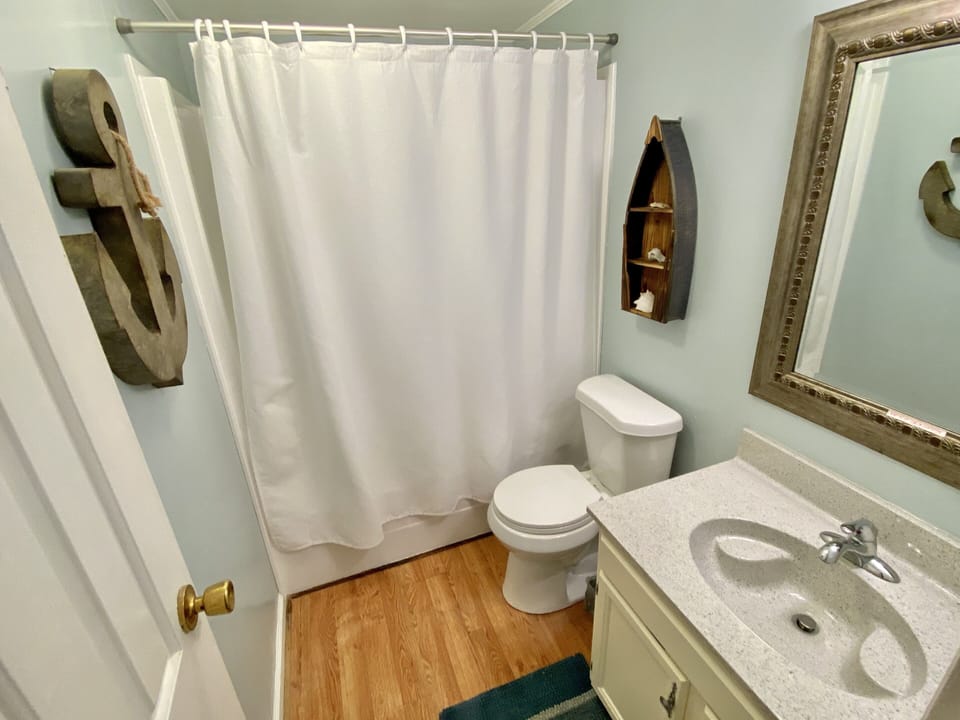 Hallway bathroom with tub 