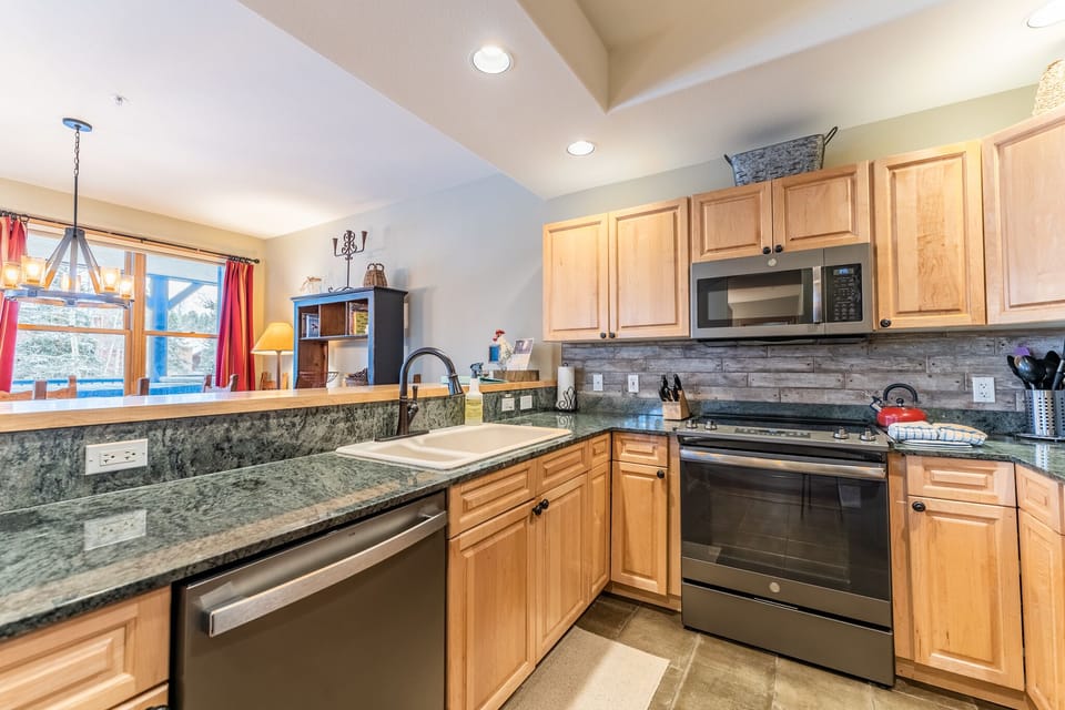 Your gourmet kitchen features granite countertops, stainless steel appliances, and warm wood cabinets—perfect for preparing memorable meals together.