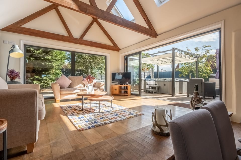 Ground floor: The spacious sofa room with stunning bi-fold doors out to the garden