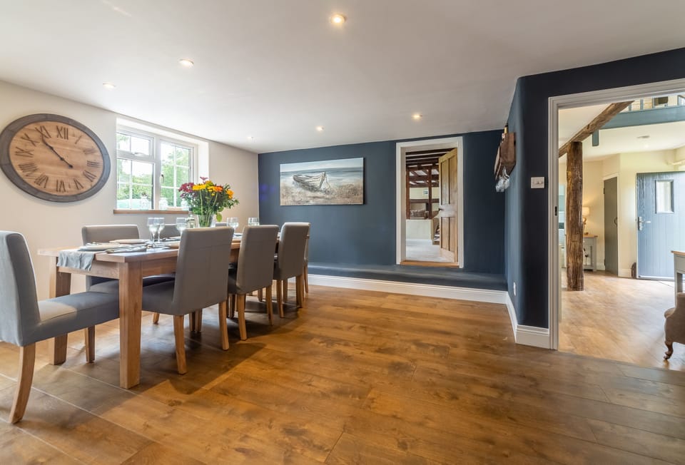 Ground floor: Dining table and chairs seating eight guests comfortably